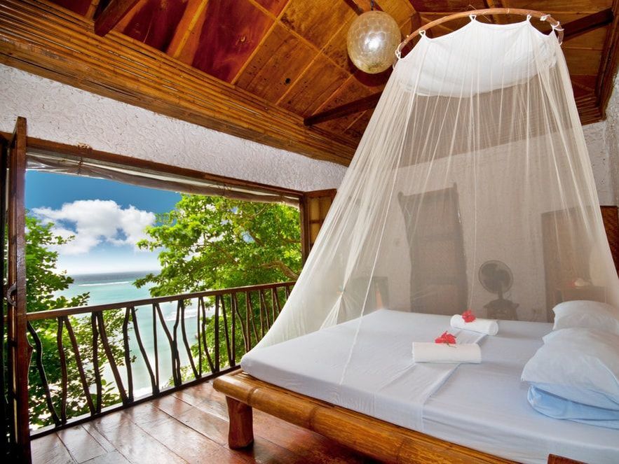 Canopy bed overlooking Caribbean sea 